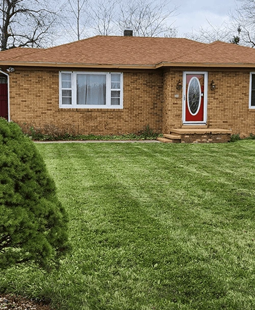 Neatly edged sidewalk with trimmed grass and a clean, polished look