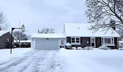 Driveway cleared of snow with clean pathways after salting service